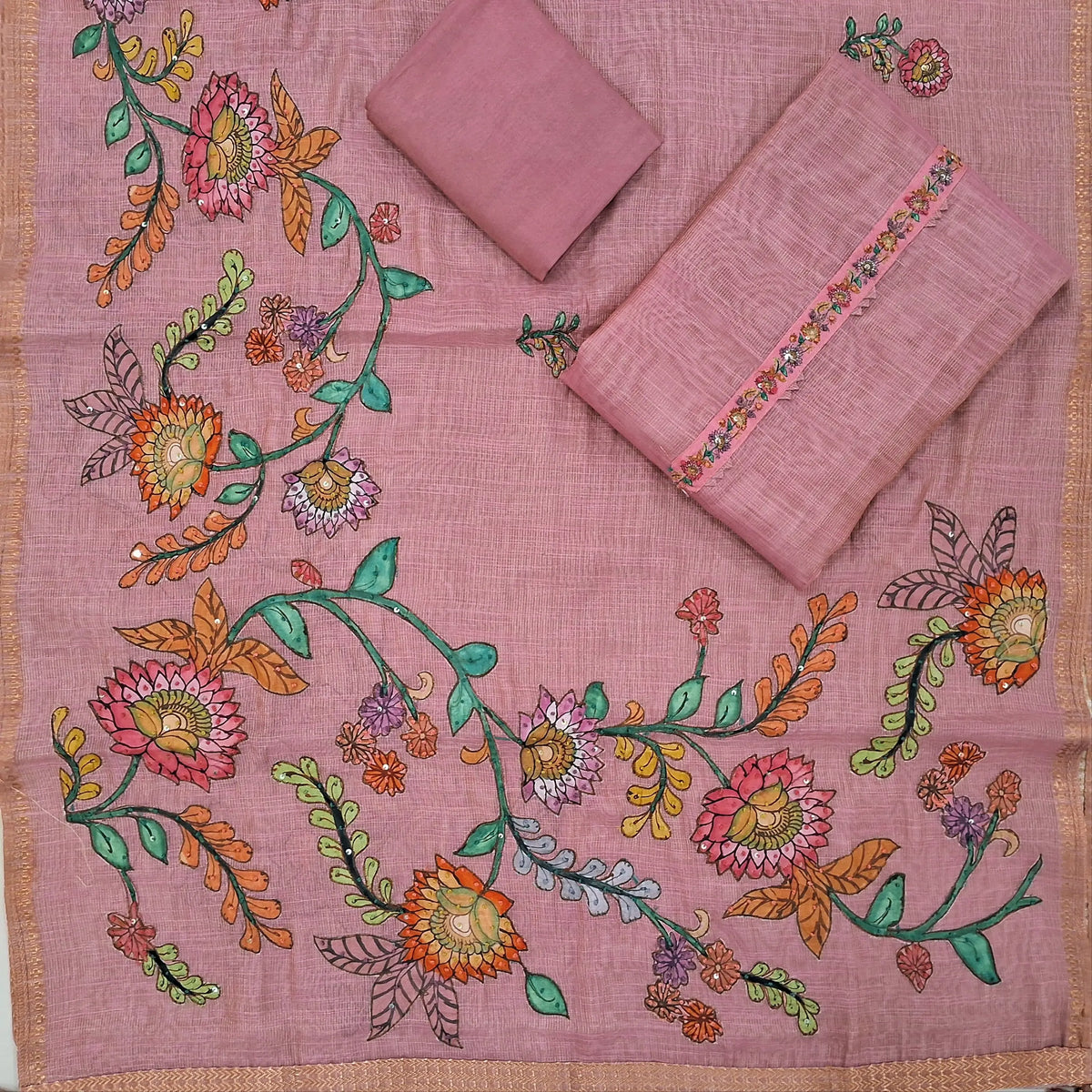 Pastel pink with golden tint pure tissue linen unstitched salwar material,floral design with french knot & sequins work on yoke ( light weight,lining needed)santoon bottom,applique work on pure tissue linen dupatta with zari woven borders. SP262806