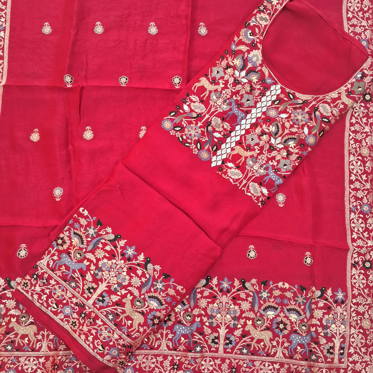 Dark pink pure uppada silk unstitched salwar material, (lining needed)round neck, thread weaving and zari woven, real mirror work on yoke,rich daman border,matching santoon bottom,pure uppada silk with rich Meenakari weaving dupatta with pallu. SP263012