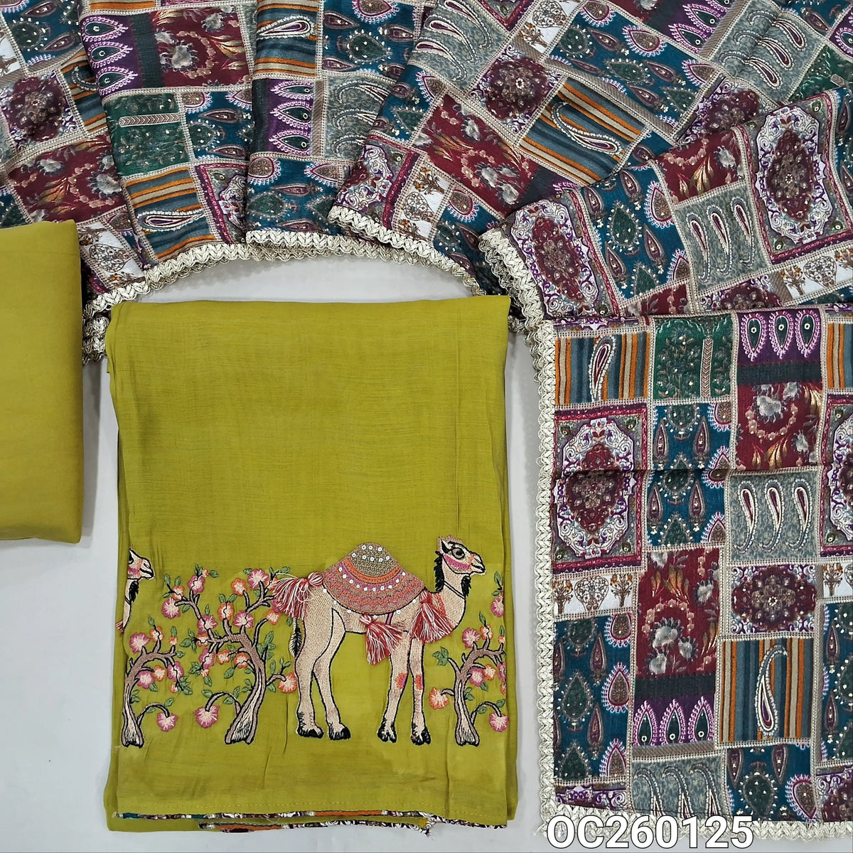 Mehandhi green mul chanderi unstitched salwar material,printed taping & tassles on yoke,camel design with embroidery work on daman,( lining needed)silk cotton bottom, multicoloured digital printed crinkled chinon silk dupatta with lace tapping. OC260125