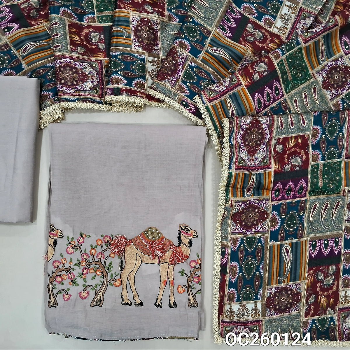 Light greyish beige mul chanderi unstitched salwar material,printed taping & tassles on yoke,camel design with embroidery on daman,( lining needed)silk cotton bottom, multicoloured digital printed crinkled chinon silk dupatta with lace tapping. OC260124
