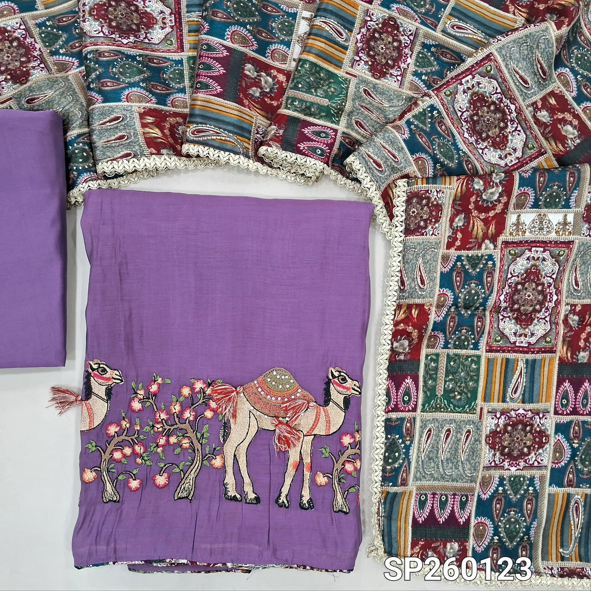 Purple mul chanderi unstitched salwar material,printed taping & tassles on yoke,camel design with embroidery on daman,( lining needed)silk cotton bottom, multicoloured digital printed crinkled chinon silk dupatta with lace tapping. OC260123