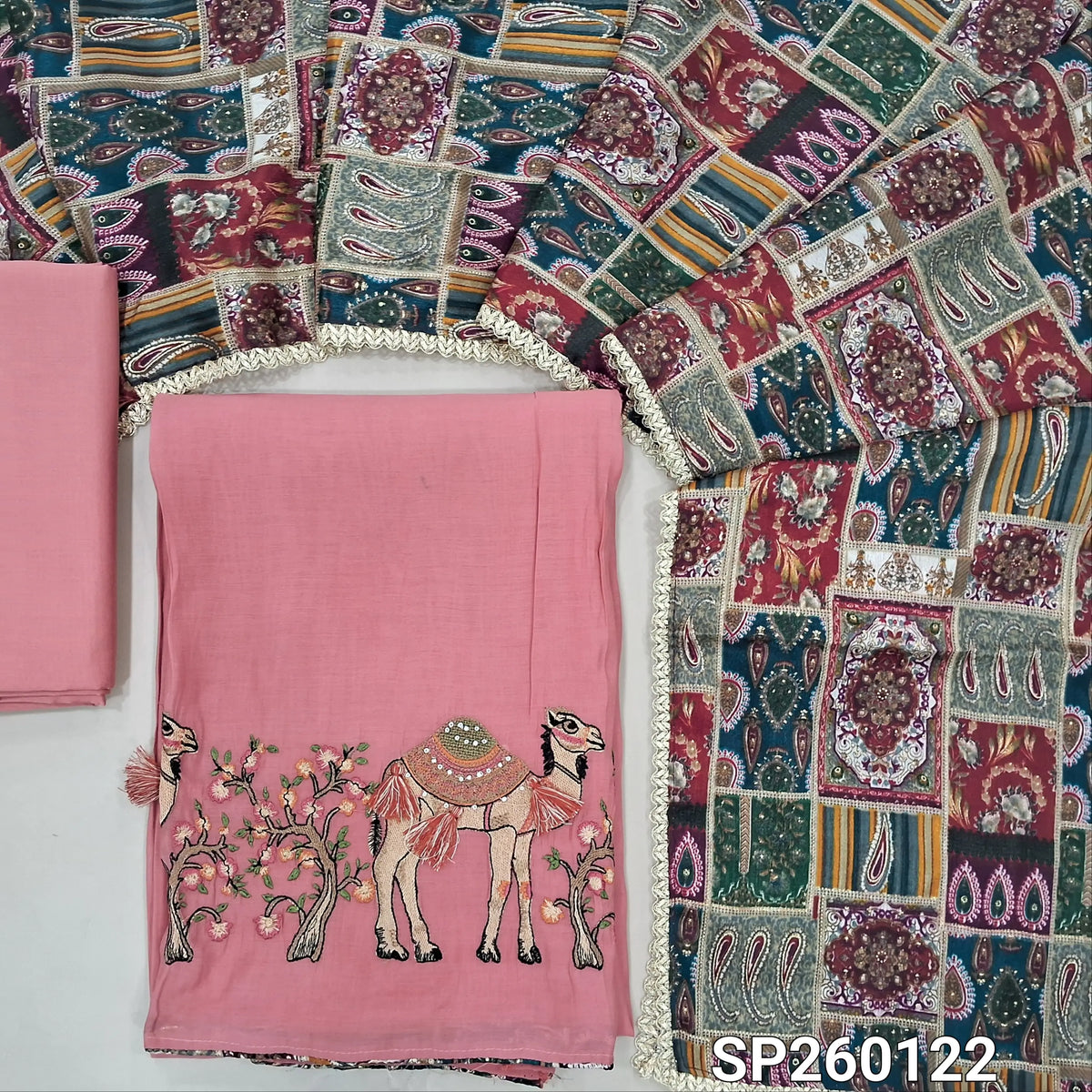 Pastel pink mul chanderi unstitched salwar material,printed taping & tassles on yoke,camel design with embroidery on daman,( lining needed)silk cotton bottom, multicoloured digital printed crinkled chinon silk dupatta with lace tapping. OC260122