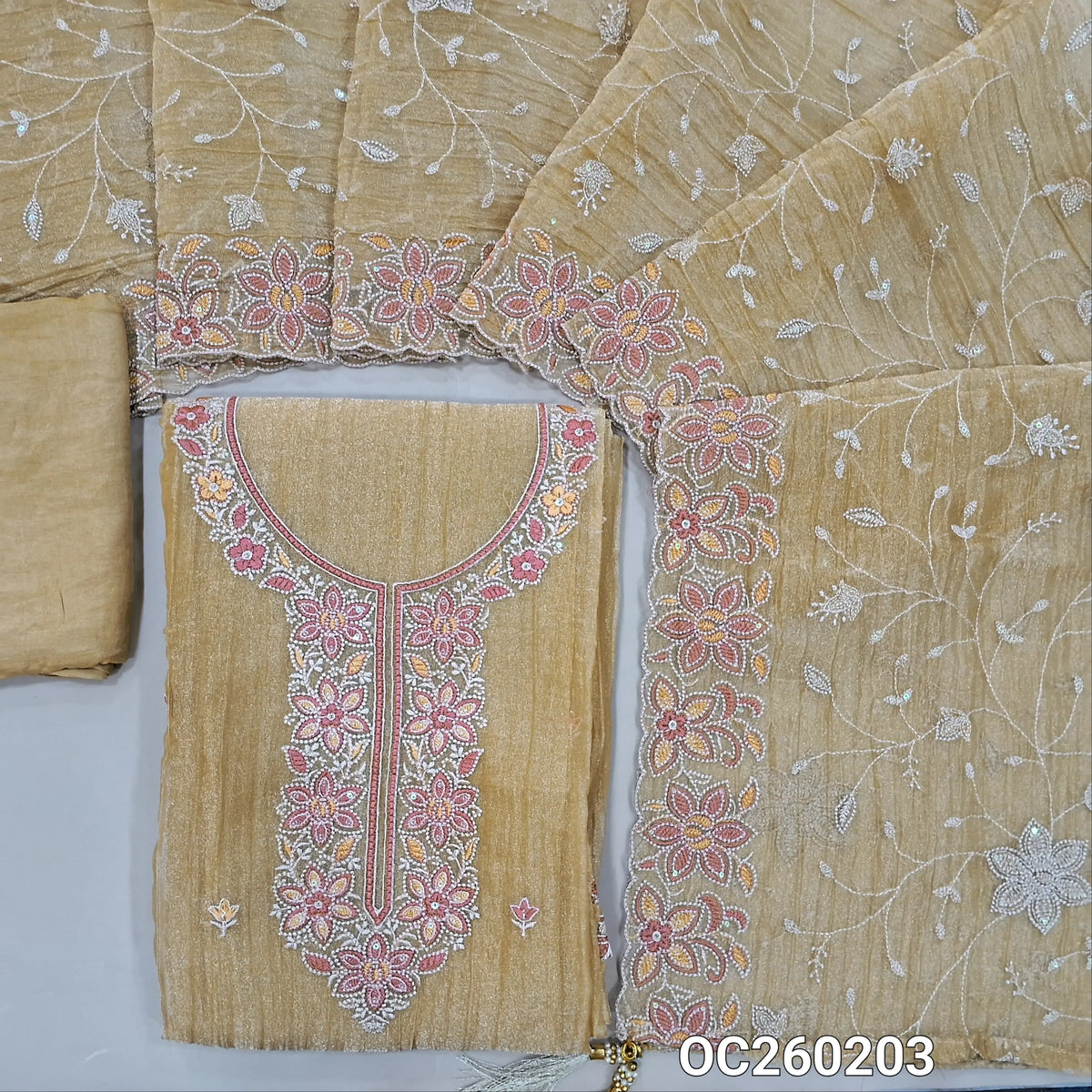Golden beige with golden tint crinkled tissue silk cotton unstitched salwar material, embroidery work on yoke& daman,(lining needed)santoon bottom, rich thread embroidery & sequins work on crinkled tissue silk dupatta with borders. OC260203