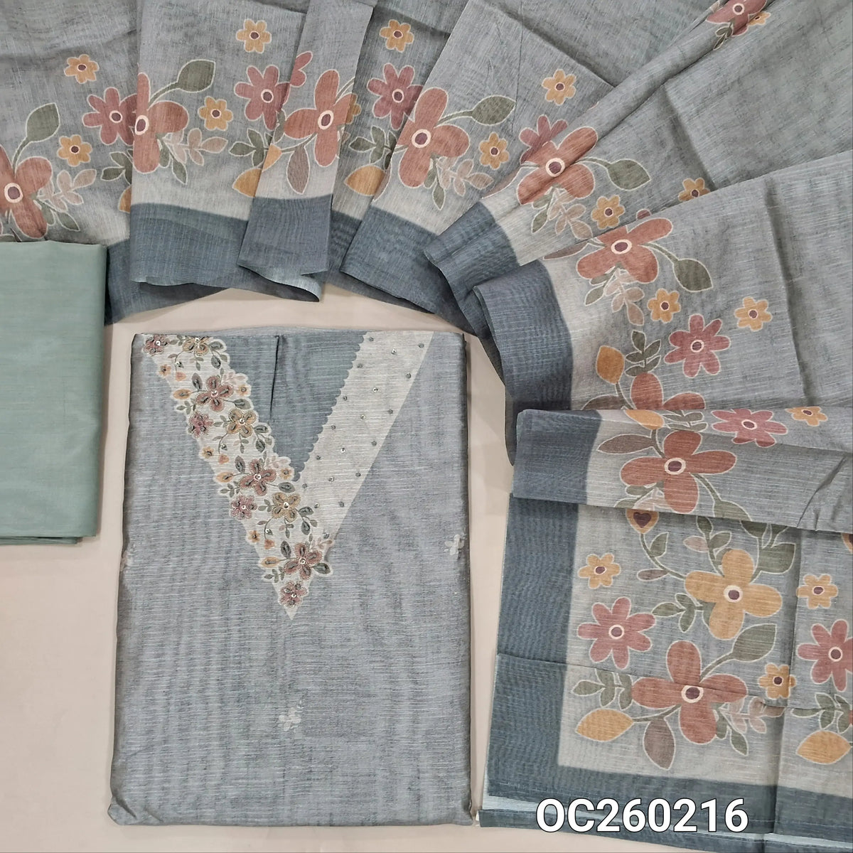 Grey fancy silk cotton unstitched salwar material, printed yoke with french knot & sequins work on yoke, printed all over,(lining needed)spun cotton bottom, digital printed silk cotton dupatta. OC260216