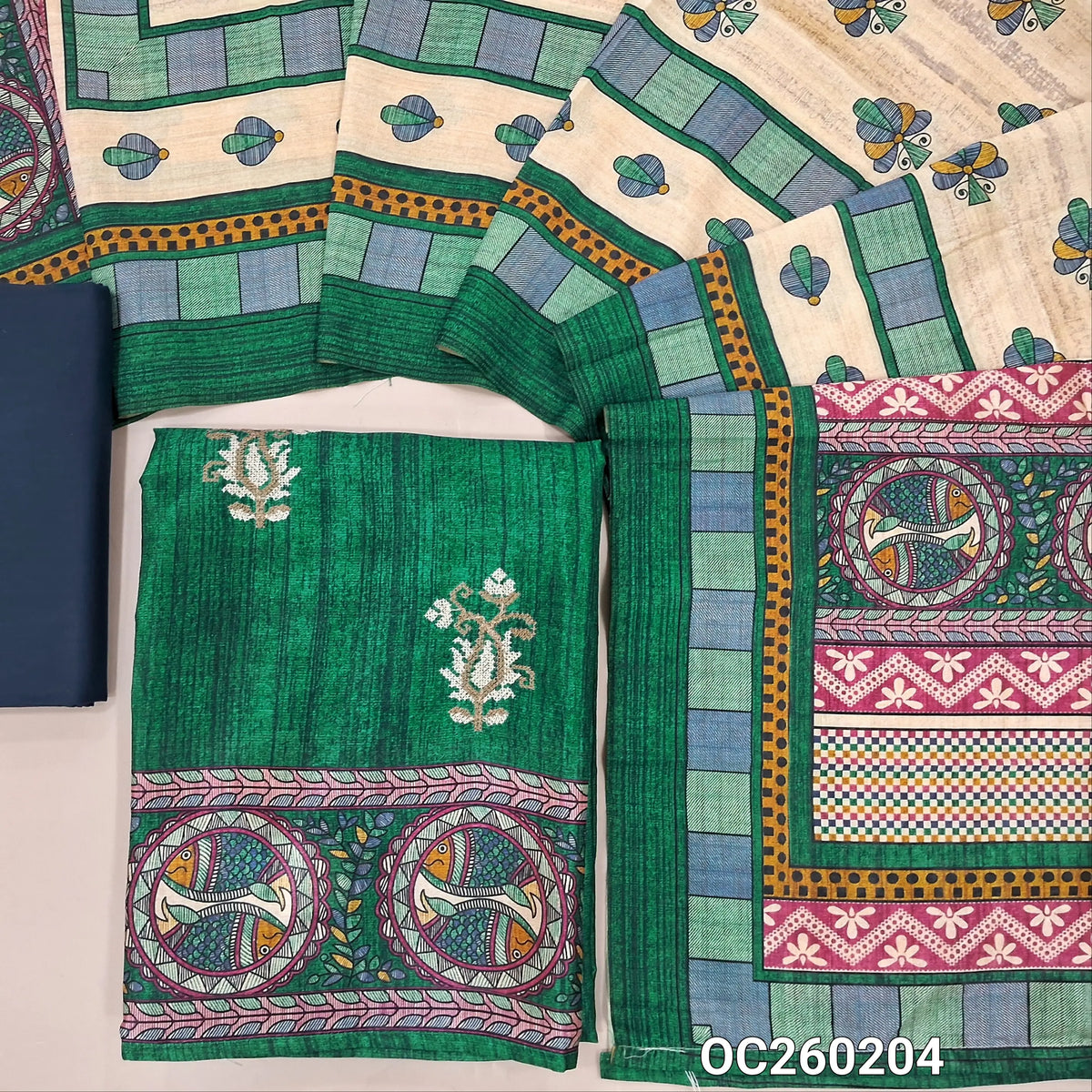 Dark green semi tussar unstitched salwar material,cross stitch work on front,madhubani printed daman,(lining needed)blue spun cotton bottom,digital printed semi tussar dupatta with madhubani printed pallu. OC260204
