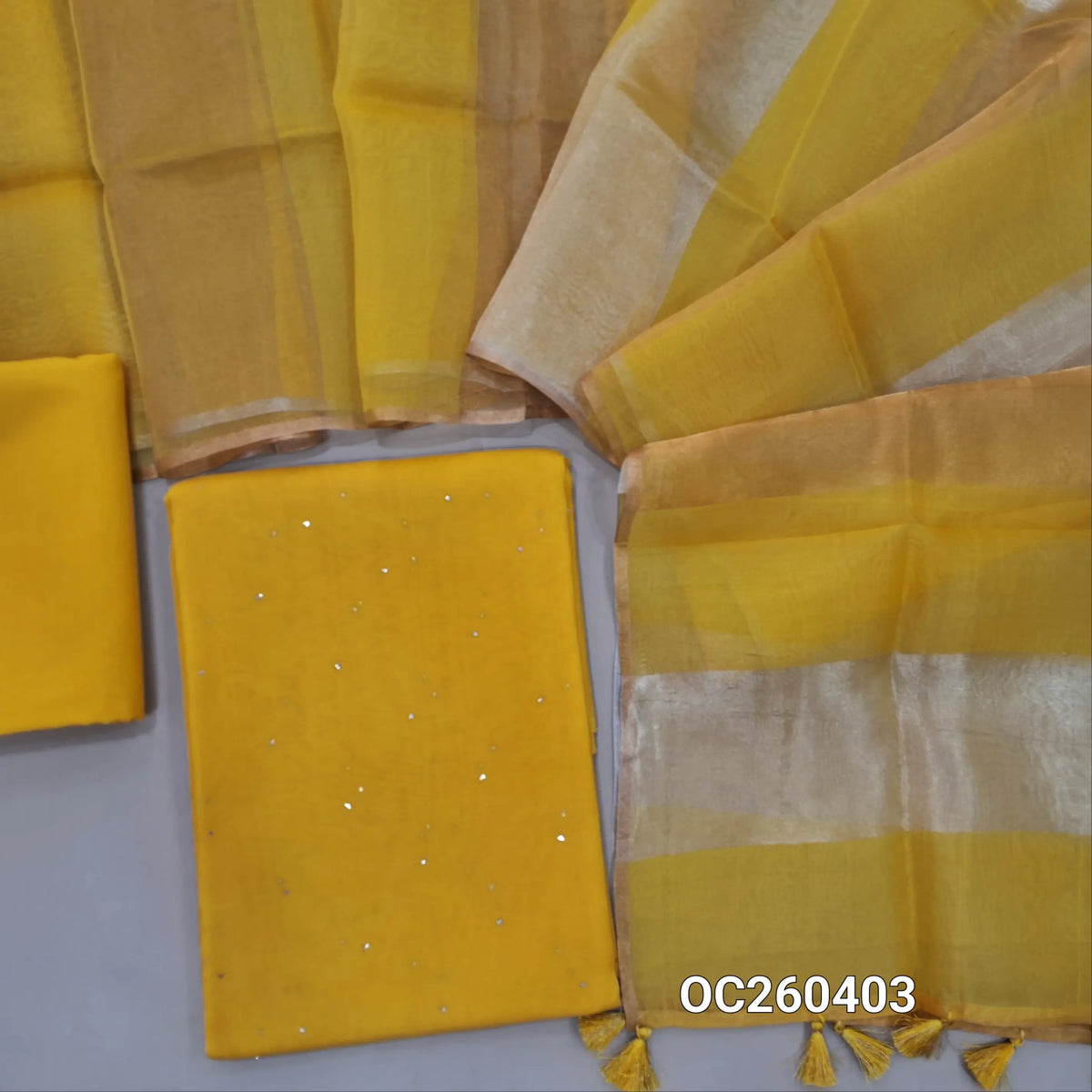 Yellow pure organza silk unstitched salwar material, mukesh work all over,(lining needed)silk cotton bottom, silver and gold tissue on full length organza silk dupatta with tassles. OC260403