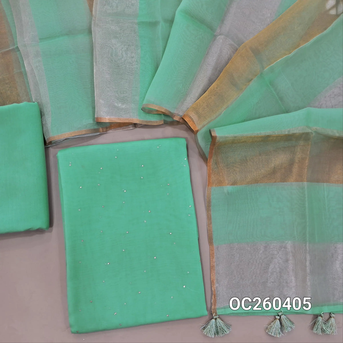 Sea green pure organza silk unstitched salwar material, mukesh work all over,(lining needed)silk cotton bottom, silver and gold tissue on full length organza silk dupatta with tassles. OC260405