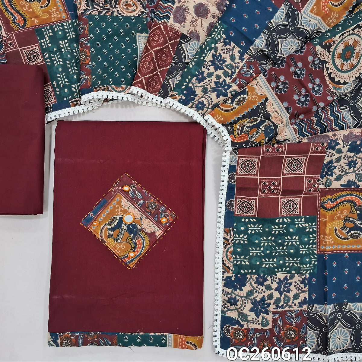 Dark maroon designer dabu cotton unstitched salwar material, applique, kantha stitch and mirror work on yoke and daman (Lining Optional) matching bottom, printed pure cotton dupatta with lace tapping, printed dabu cotton over coat. OC260612