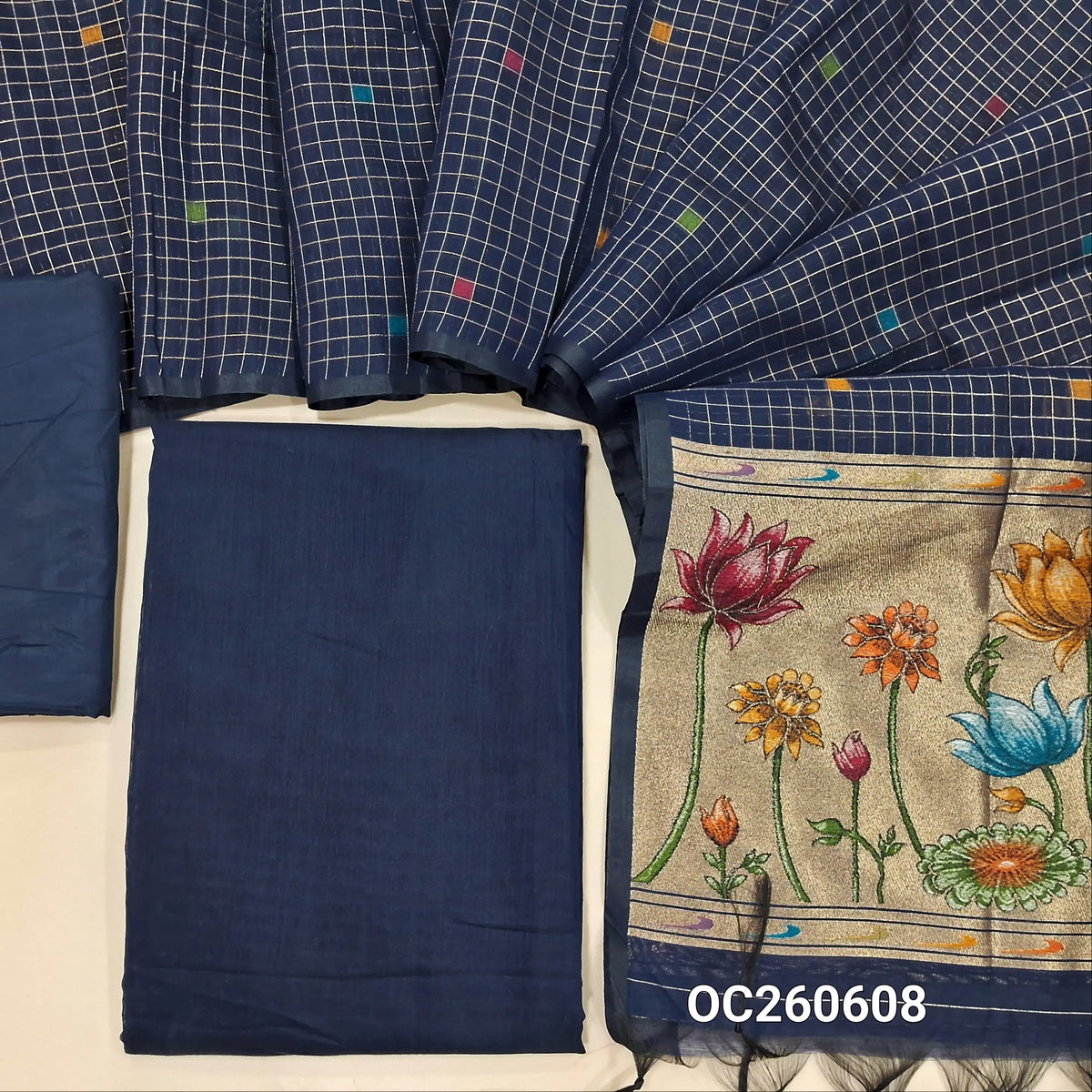 Dark blue premium silk cotton unstitched salwar material,(lining needed)matching silky bottom, zari checks with thread woven buttas on silk cotton dupatta with tissue pallu with rich weaving. OC260608