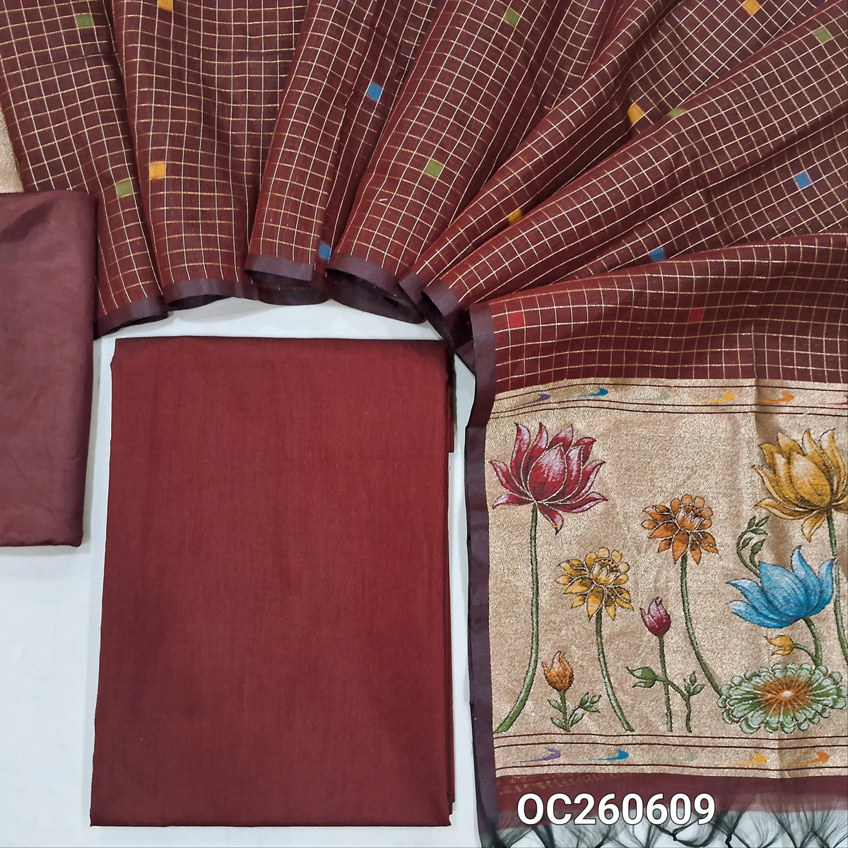 Dark maroon premium silk cotton unstitched salwar material,(lining needed)matching silky bottom, zari checks with thread woven buttas on silk cotton dupatta with tissue pallu with rich weaving. OC260609