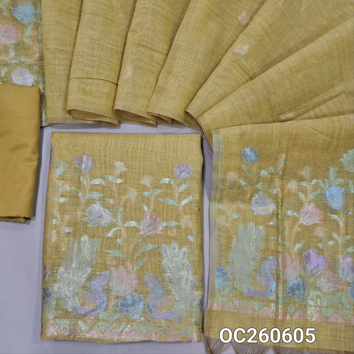 Sandal yellow premium silk cotton unstitched salwar material,buttas on front,rich pastel weaving on daman,(lining needed)silky bottom, buttas on full length silk cotton dupatta with rich pastel zari weaving pallu. OC260605