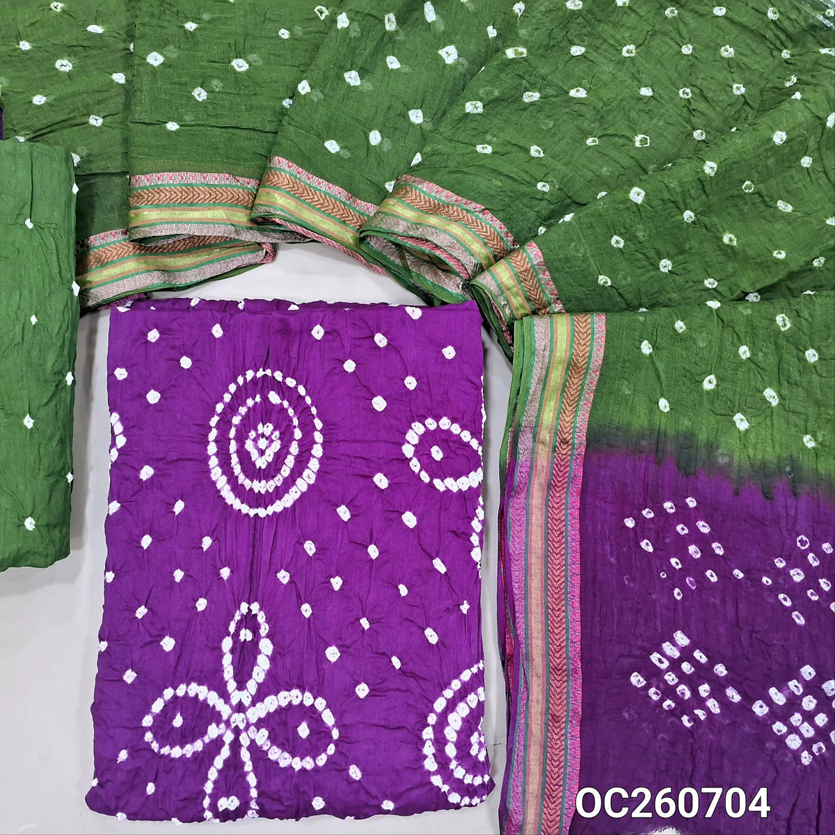 Purple bandhini tie and dye pure cotton unstitched salwar material,(lining needed)green tie and dye cotton bottom,dual shaded tie and dye mul cotton dupatta with resham borders. OC260704