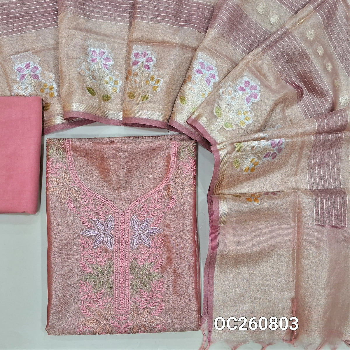 Pastel pink with golden tint pure tissue organza silk unstitched salwar material, thread embroidery work  on yoke,(lining needed)santoon bottom,benarsai weaving on tissue organza silk dupatta with meenakari borders. OC260803