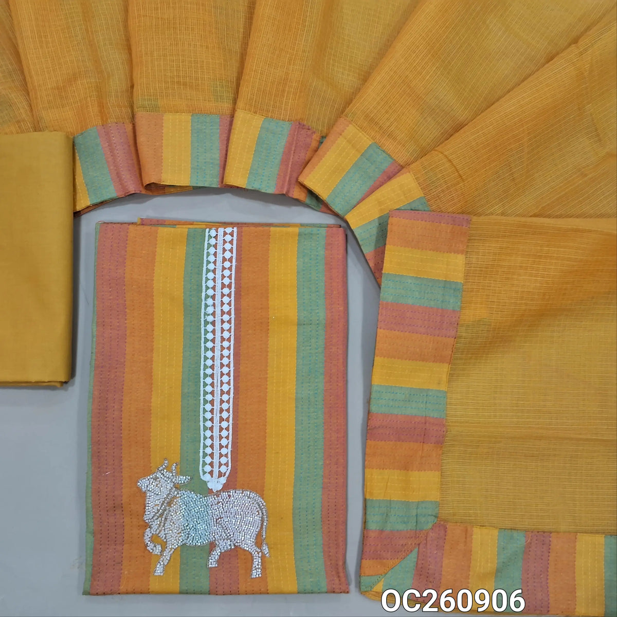 Multicoloured spun cotton unstitched salwar material,pichwai is highlighted with cut bead work on  yoke,kantha stitch on front,(lining needed)yellow cotton bottom, kota silk cotton dupatta with broad tapping. OC260906