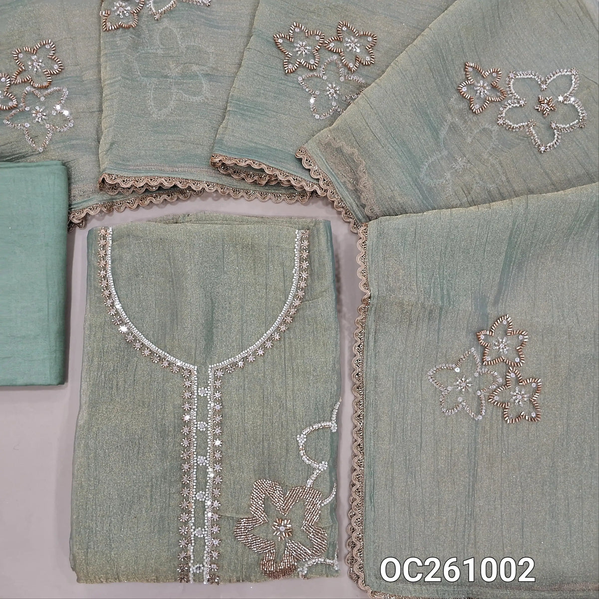 Pastel green with golden tint pure crinkled tissue organza silk unstitched salwar material,rich bead and zarodzi work on yoke and front,(lining needed)santoon bottom,rich bead work on crinkled tissue silk cotton dupatta with lace tapping. OC261002