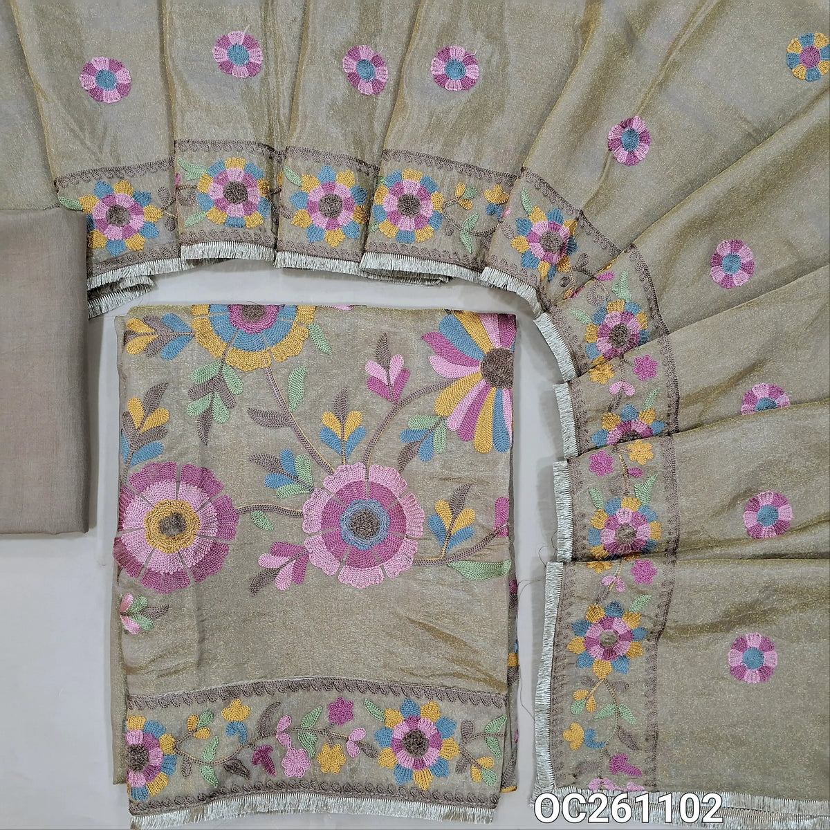 Light chocolate brown with golden tint premium tissue silk unstitched salwar material, thread embroidery on yoke,rich embroidery on front,( Lining Needed)santoon bottom, thread embroidery on tissue silk dupatta with rich borders & tapping. OC261102