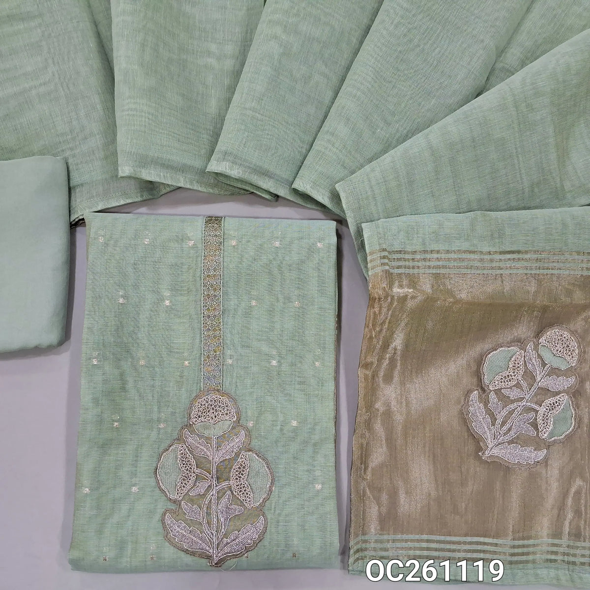 Pastel green silk cotton unstitched salwar material,applique work and zari yoke, zari buttas all over,rich daman,(lining needed)santoon bottom,silk cotton dupatta with tissue pallu with applique work. OC261119