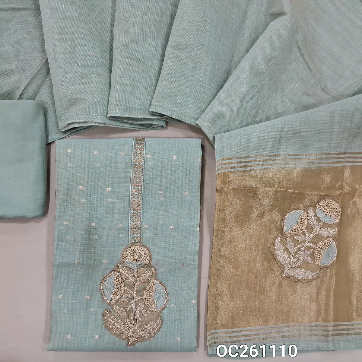 Powder blue silk cotton unstitched salwar material,applique work and zari yoke, zari buttas all over,rich daman,(lining needed)santoon bottom,silk cotton dupatta with tissue pallu with applique work. OC261110