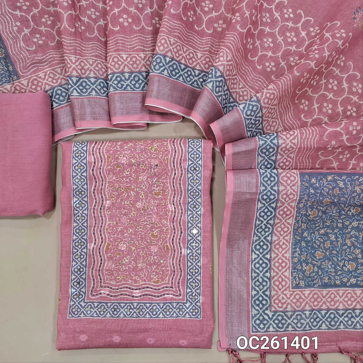Pastel pink jakard linen unstitched salwar material,printed yoke with sequins work, printed and self woven buttas all over,  (Lining Needed)santoon bottom, digital printed premium semi linen dupatta with silver tissue borders. OC261401