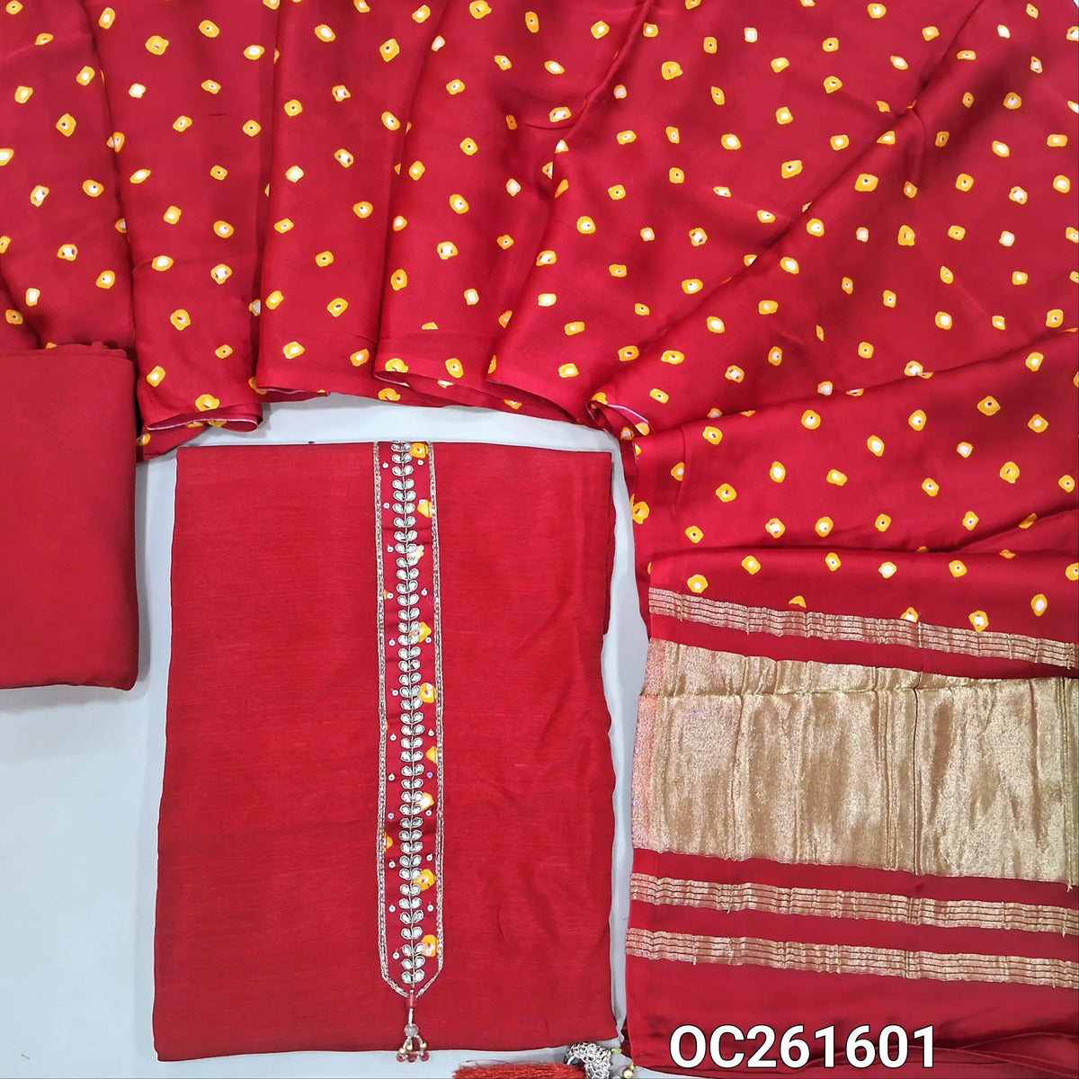 Designer red raw silk unstitched salwar material,zari, zarodzi and sequins on yoke, (lining needed)santoon bottom, tie and dye pure gaiji silk dupatta with gold tissue pallu. OC261601