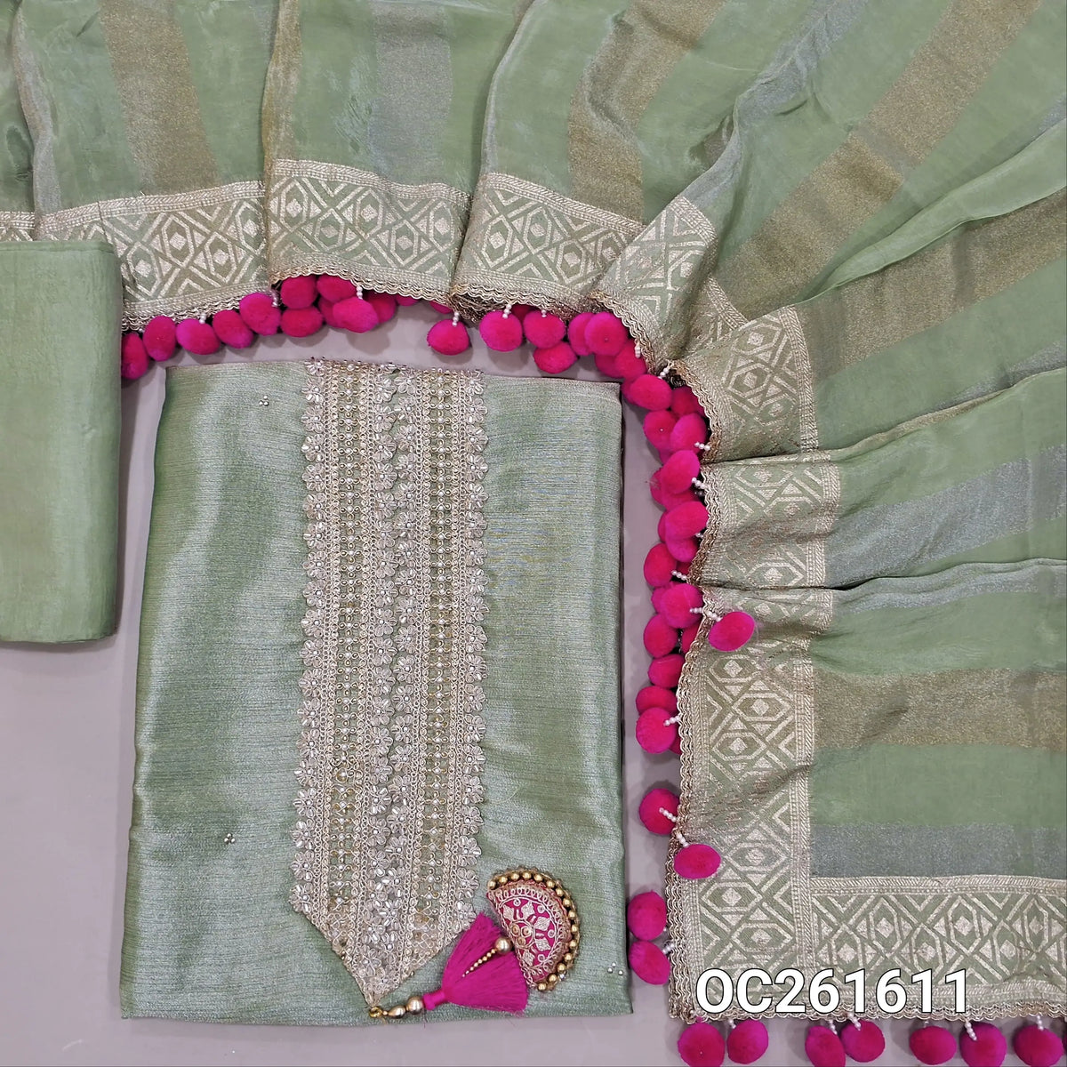 Pastel green with golden tint premium tissue silk unstitched salwar material,zari, zarodzi & sequins on yoke,(Lining Needed)silk bottom,silver & gold zari weaving tissue silk dupatta with handmade pom pom tapping & borders. OC261611