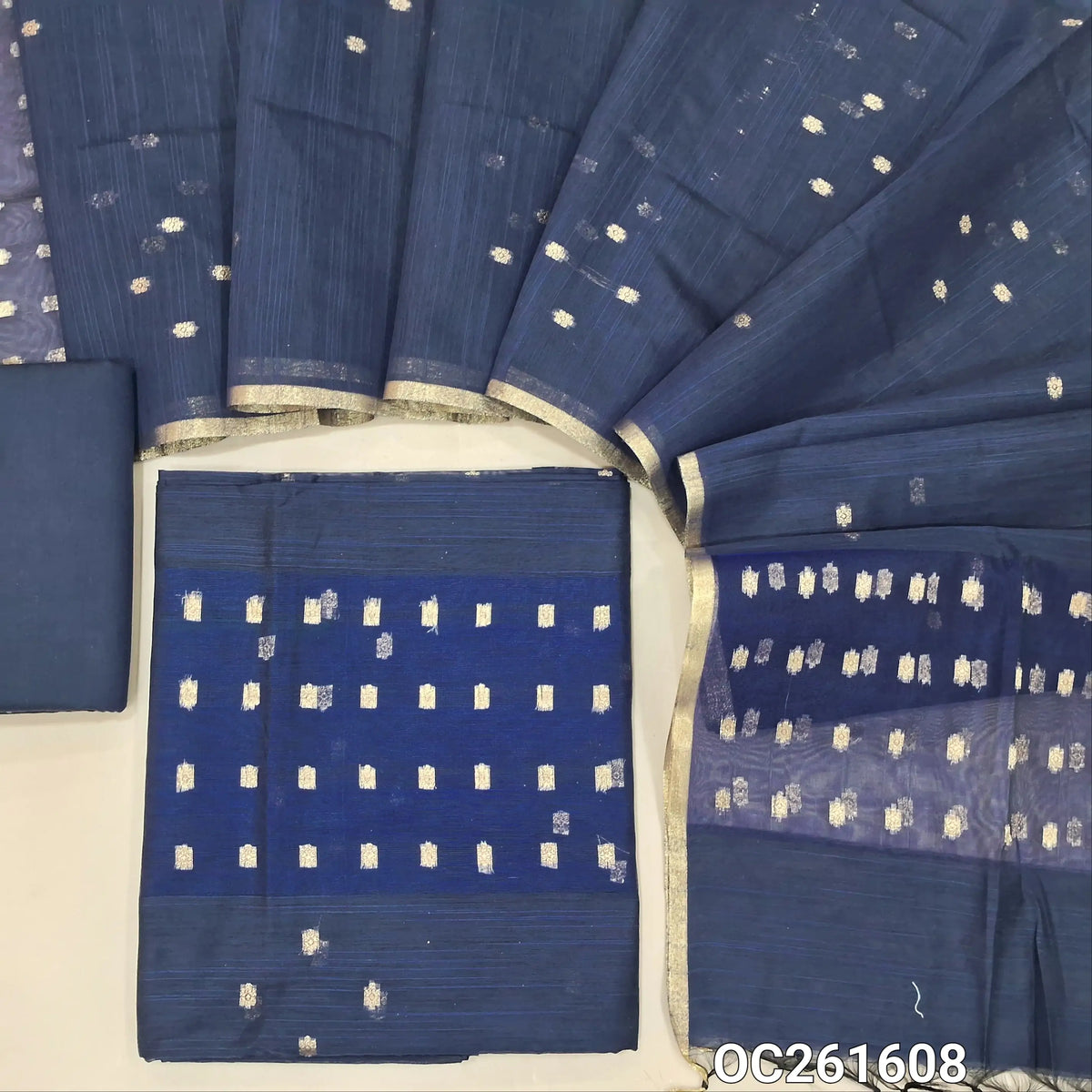 Dark blue slub silk cotton unstitched salwar material, zari woven buttas all over,organza daman(thin fabric, lining needed)silk cotton bottom, buttas on slub silk cotton dupatta with organza pallu. OC261608