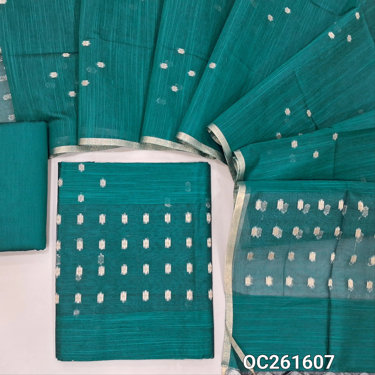 Teal green slub silk cotton unstitched salwar material, zari woven buttas all over,organza daman(thin fabric, lining needed)silk cotton bottom, buttas on slub silk cotton dupatta with organza pallu. OC261607