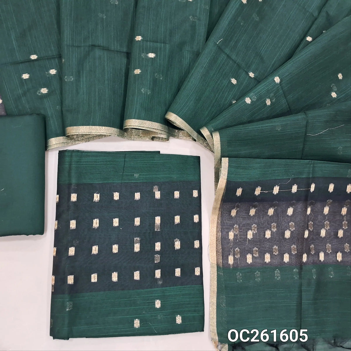 Bottle green slub silk cotton unstitched salwar material, zari woven buttas all over,organza daman(thin fabric, lining needed)silk cotton bottom, buttas on slub silk cotton dupatta with organza pallu. OC261605
