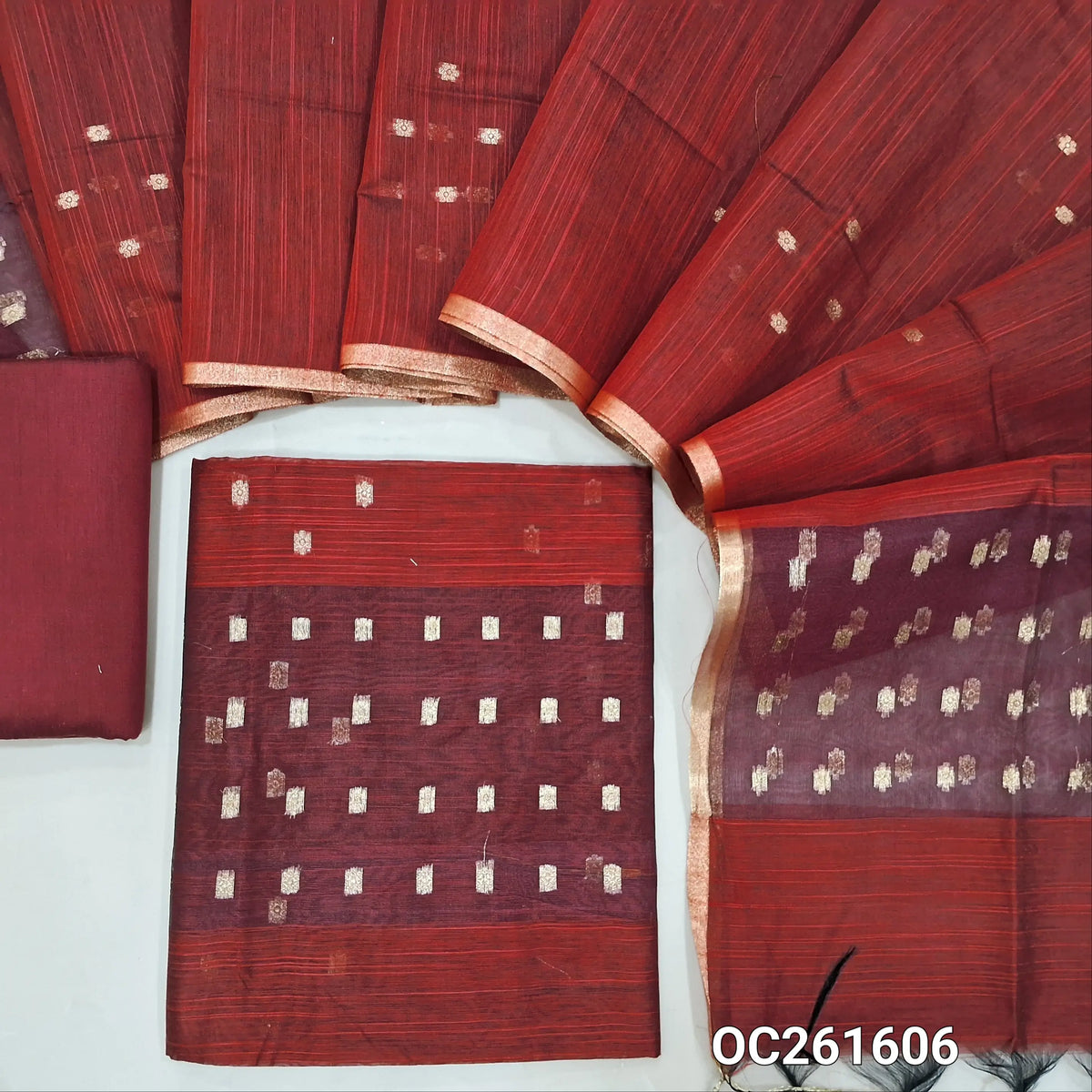 Dark maroon slub silk cotton unstitched salwar material, zari woven buttas all over,organza daman(thin fabric, lining needed)silk cotton bottom, buttas on slub silk cotton dupatta with organza pallu. OC261606