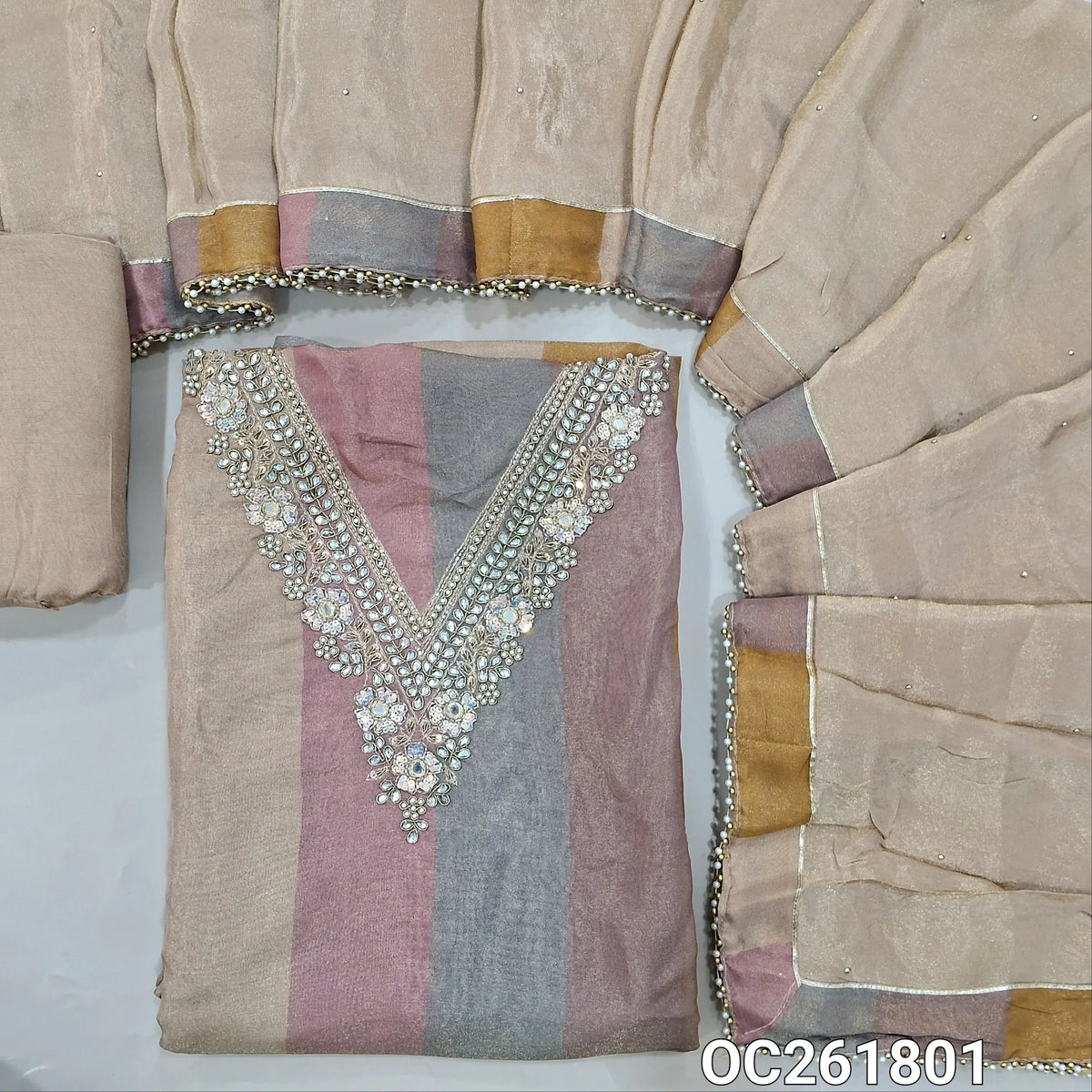 Multicoloured with golden tint tissue organza silk unstitched salwar material, V neck with zarodzi, sequins and pearl bead on yoke, (lining needed)beige santoon bottom, sequins on tissue silk dupatta with pearl beaded tapping. OC261801