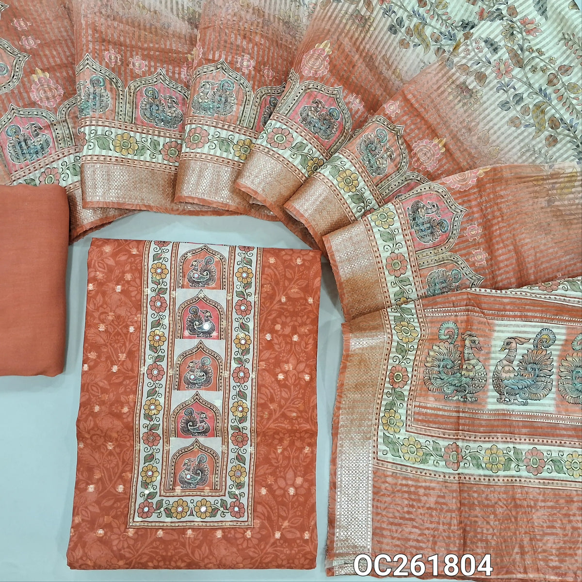 Brick red digital printed silk cotton unstitched salwar material,printed yoke, zari woven buttas on front,(lining needed)spun cotton bottom, digital printed tissue organza dupatta with benarasi zari woven borders. OC261804