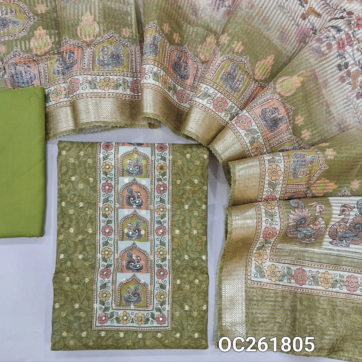 Green digital printed silk cotton unstitched salwar material,printed yoke, zari woven buttas on front,(lining needed)spun cotton bottom, digital printed tissue organza dupatta with benarasi zari woven borders. OC261805