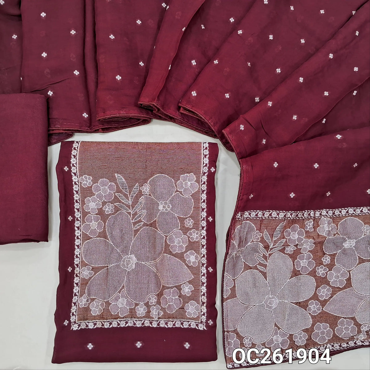 Dark maroon premium benarasi kora unstitched salwar material, rich silver zari weaving on yoke,silver zari buttas all over,(Soft, Silky, Lining Needed)santoon bottom,silver zari buttas on benarasi kora dupatta with zari weaving. OC261904