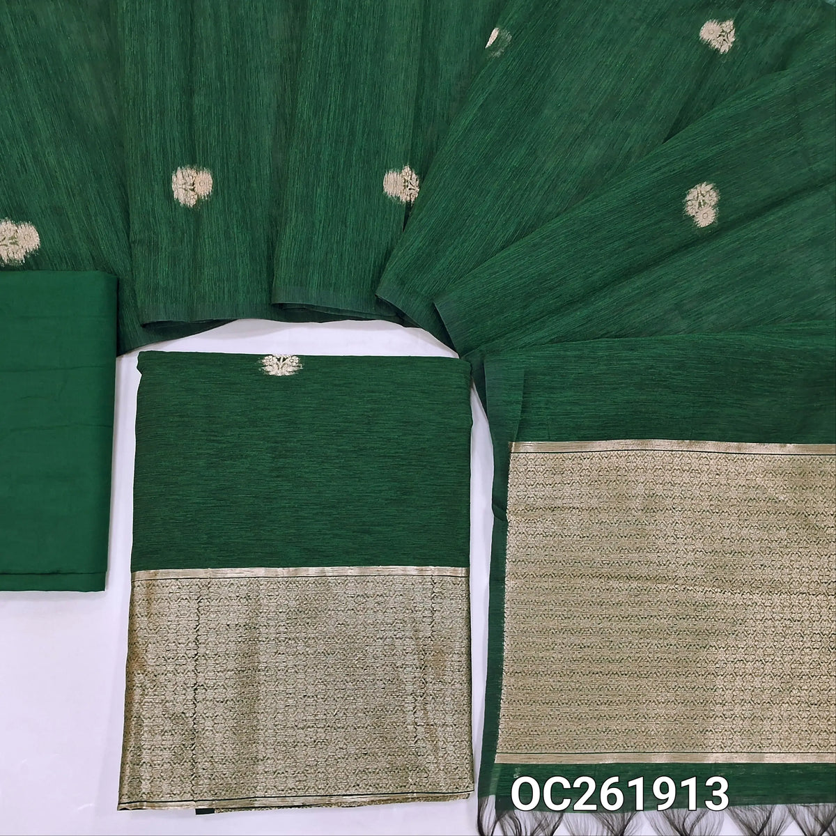 Bottle green premium tussar jamdani unstitched salwar material,antic gold zari buttas all over, rich daman,(Thin, textured, lining needed)silk cotton bottom, buttas on benarasi tussar dupatta with rich pallu. OC261913