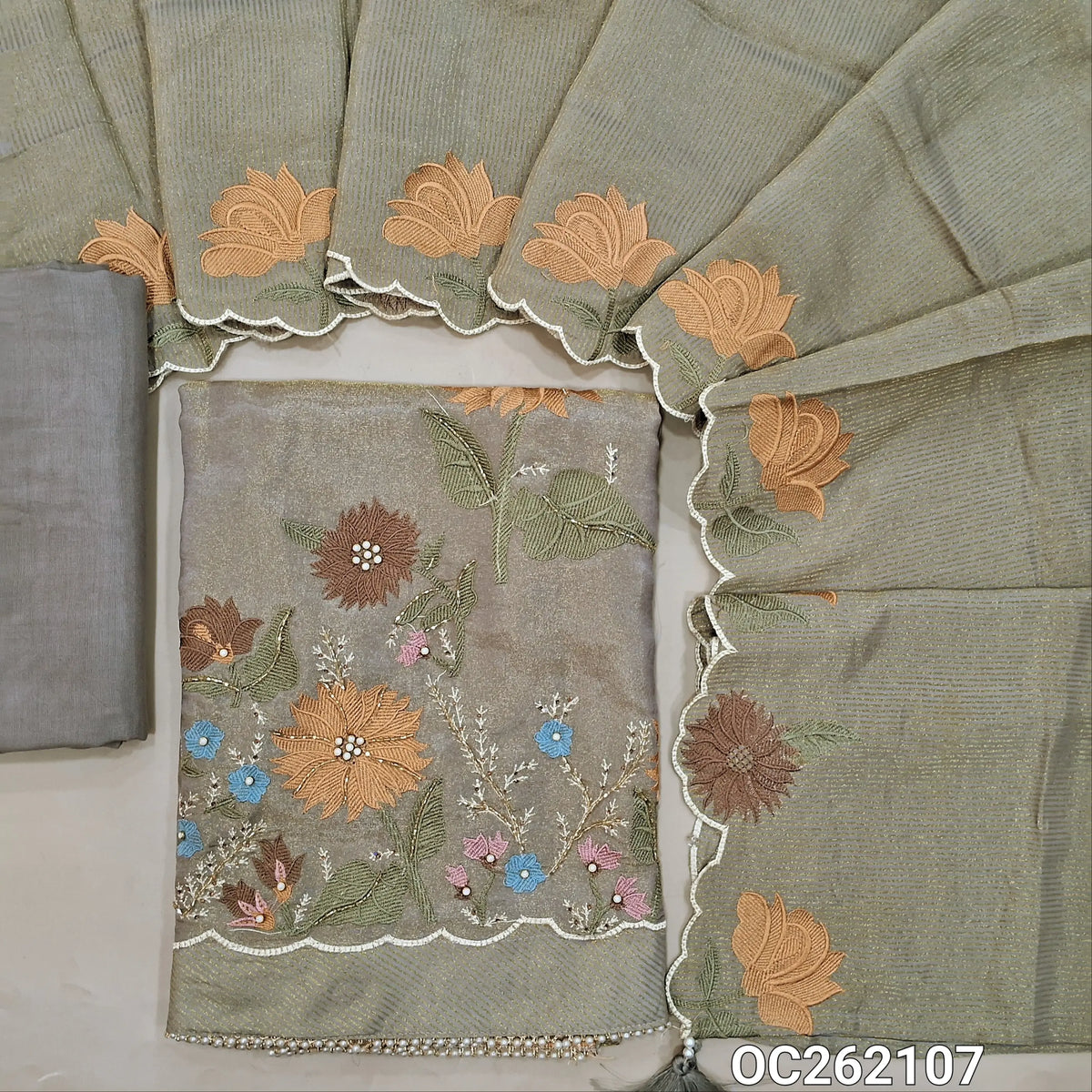 Silver grey with golden tint tissue organza silk unstitched salwar material, sequins & thread on yoke,embroidery with zarodzi & cut bead front,(Lining Needed)santoon bottom, zari lines tissue organza silk dupatta with embroidery scallop borders. OC262107
