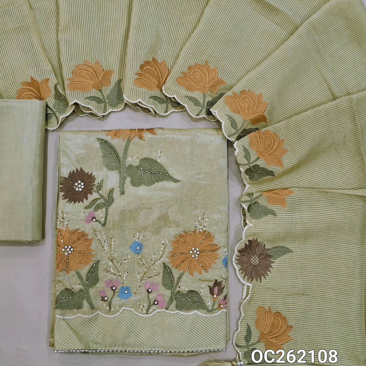Pastel green with golden tint tissue organza silk unstitched salwar material, sequins & thread on yoke,embroidery with zarodzi & cut bead front,(Lining Needed)santoon bottom, zari lines tissue organza silk dupatta with embroidery scallop borders. OC262108