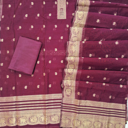 Beetroot purple benarasi zari woven silk cotton unstitched salwar material, zari buttas all over,weaving on yoke, rich daman, (Lining Needed) silky bottom,zari buttas silk cotton dupatta with rich pallu and borders. OC262101