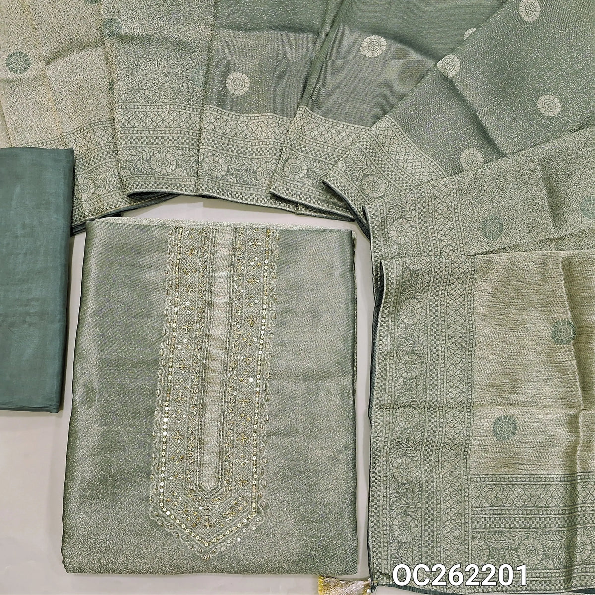 Sage green with golden tint premium tissue unstitched salwar material,zarodzi and sequins on yoke,zari woven daman,(Shimmer, Lining Needed)premium silk bottom, buttas on dual shaded benarasi tissue dupatta with borders(DRY CLEAN ONLY). OC262201
