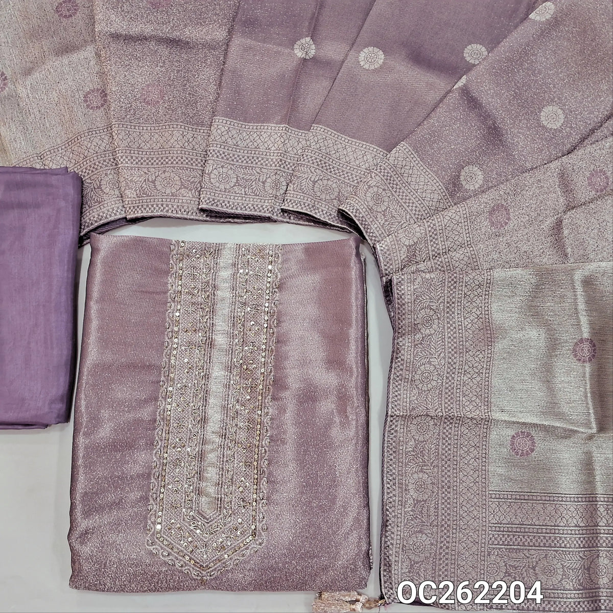 Purple with golden tint premium tissue unstitched salwar material,zarodzi and sequins on yoke,zari woven daman,(Shimmer, Lining Needed)premium silk bottom, buttas on dual shaded benarasi tissue dupatta with borders(DRY CLEAN ONLY). OC262204