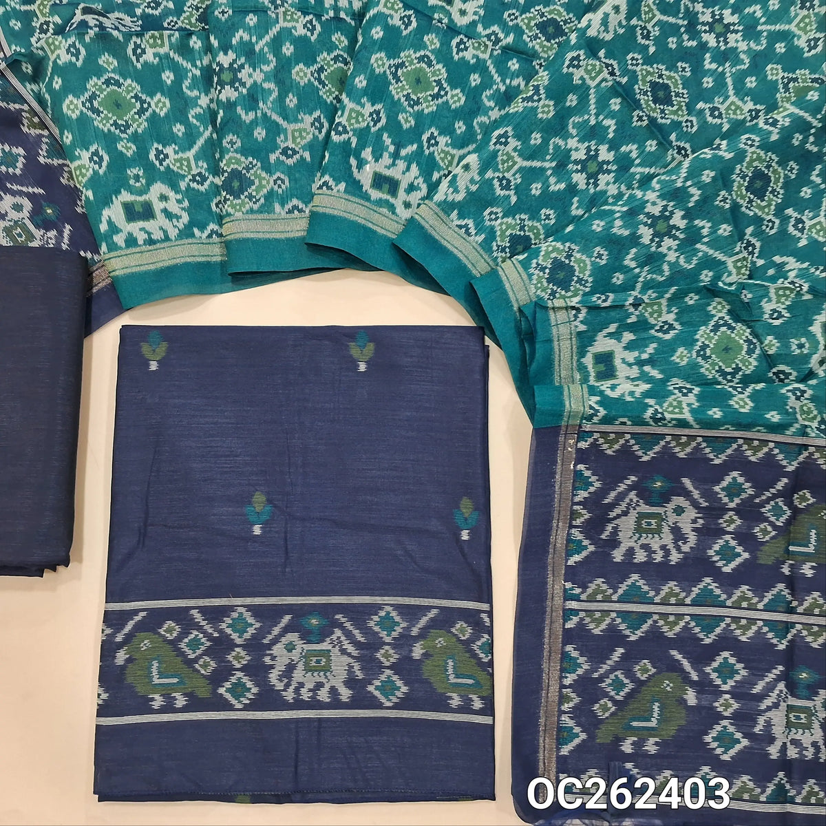 Dark blue premium silk cotton unstitched salwar material,floral buttas on front,patola weaving on daman,(lining needed)silk cotton bottom, patola weaving on full length silk cotton dupatta with contrast pallu and tassels. OC262403