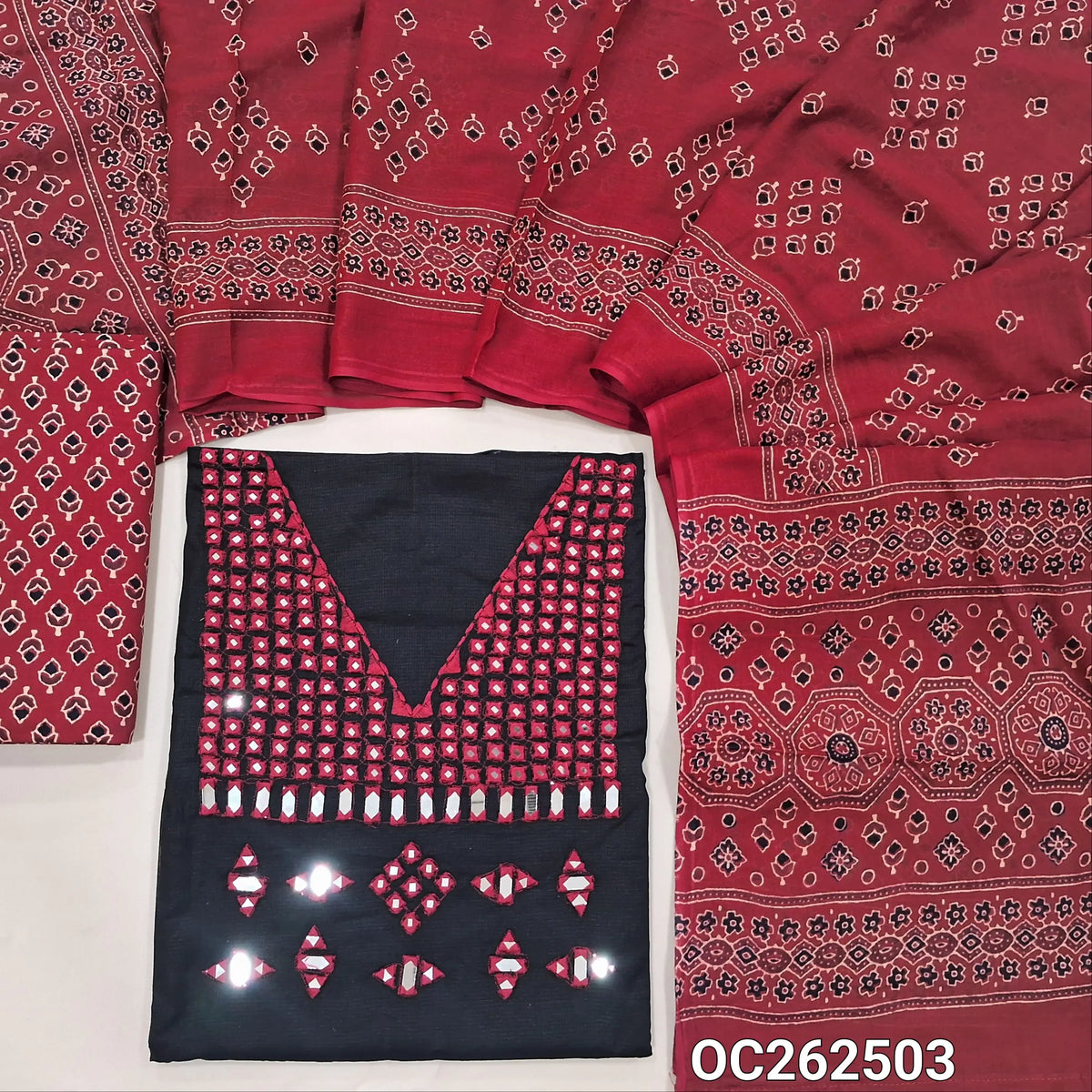 Black silk cotton unstitched salwar material,real mirror and thread work on yoke,(lining needed)reddish maroon block printed pure cotton bottom,ajrak block printed full length mul cotton dupatta. OC262503
