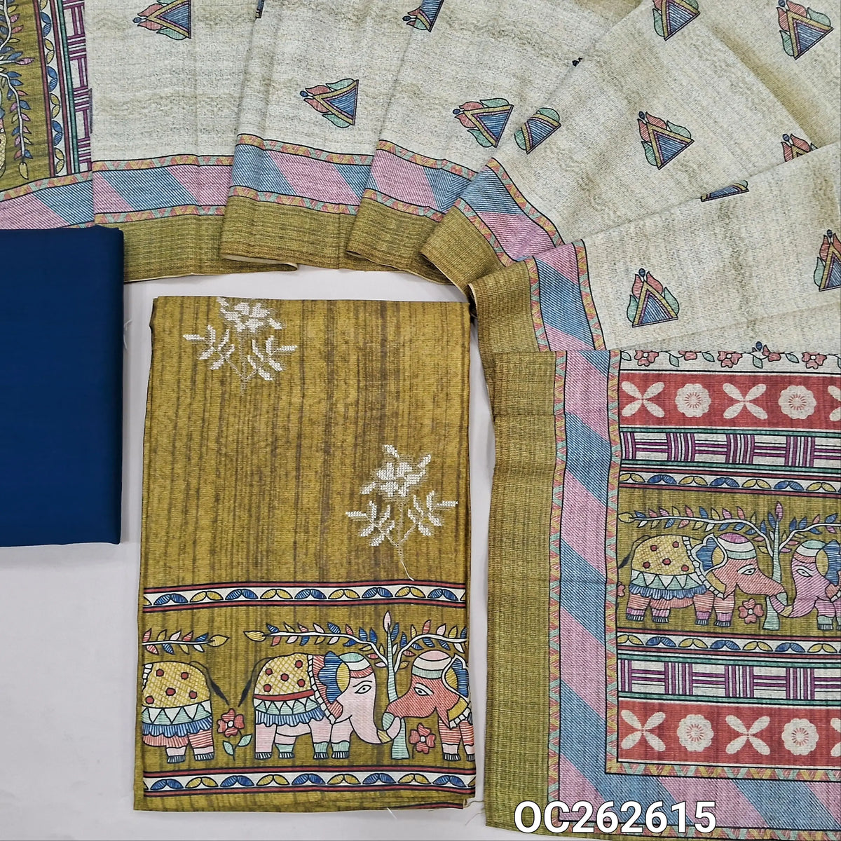 Mehandhi green semi tussar unstitched salwar material,cross stitch work on front,madhubani printed daman,(lining needed)blue spun cotton bottom,digital printed semi tussar dupatta with elephant printed pallu. OC262615