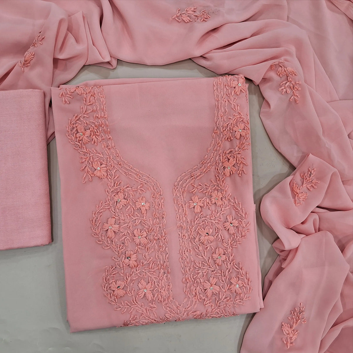 Pastel peach premium georgette unstitched salwar material, chikankari hand embroidery on yoke, sequins work (Thin, Soft, Lining Needed) matching santoon bottom, georgette dupatta with hand embroidery. OC262701