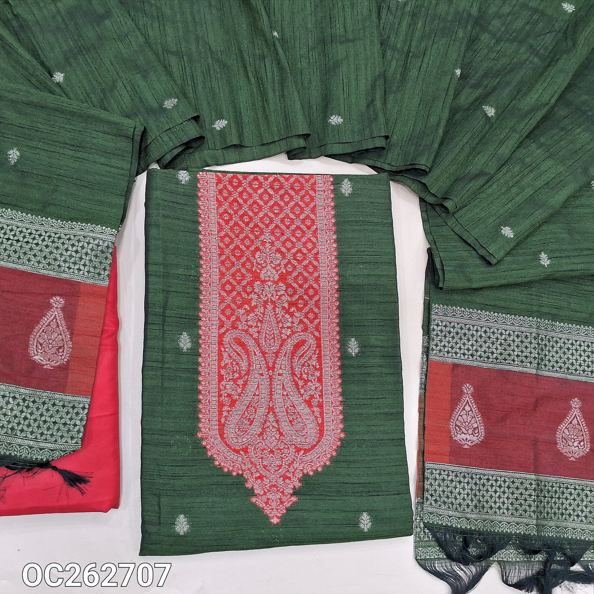 Bottle green and red premium raw silk unstitched salwar material, antique gold zari weaving on yoke and daman, buttas on front (Textured, Lining Needed) contrast silky bottom, raw silk dupatta with benarasi zari weaving. OC262707