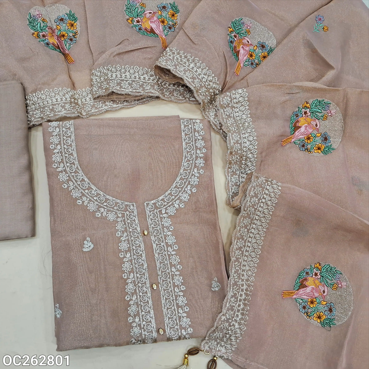 Salmon pink with golden tint premium tissue organza silk unstitched slawar material, rich zari work on yoke and daman, embroidery on front (Thin, Lining Needed) matching santoon bottom, tissue organza silk dupatta with embroidery. OC262801