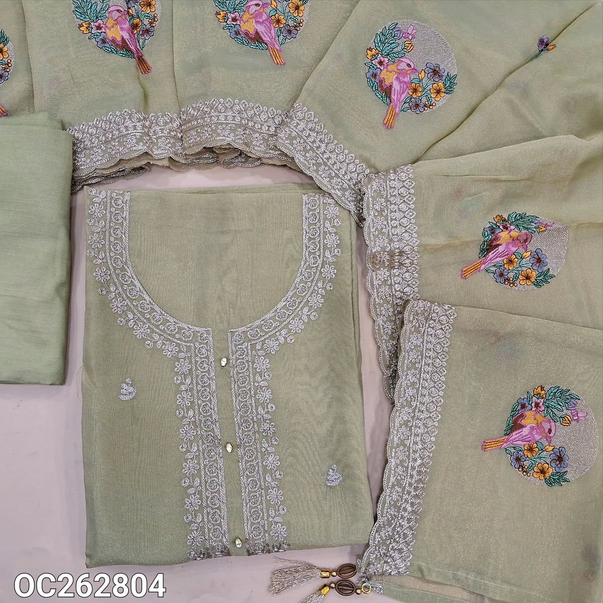 Pastel green with golden tint premium tissue organza silk unstitched slawar material, rich zari work on yoke and daman, embroidery on front (Thin, Lining Needed) matching santoon bottom, tissue organza silk dupatta with embroidery. OC262804