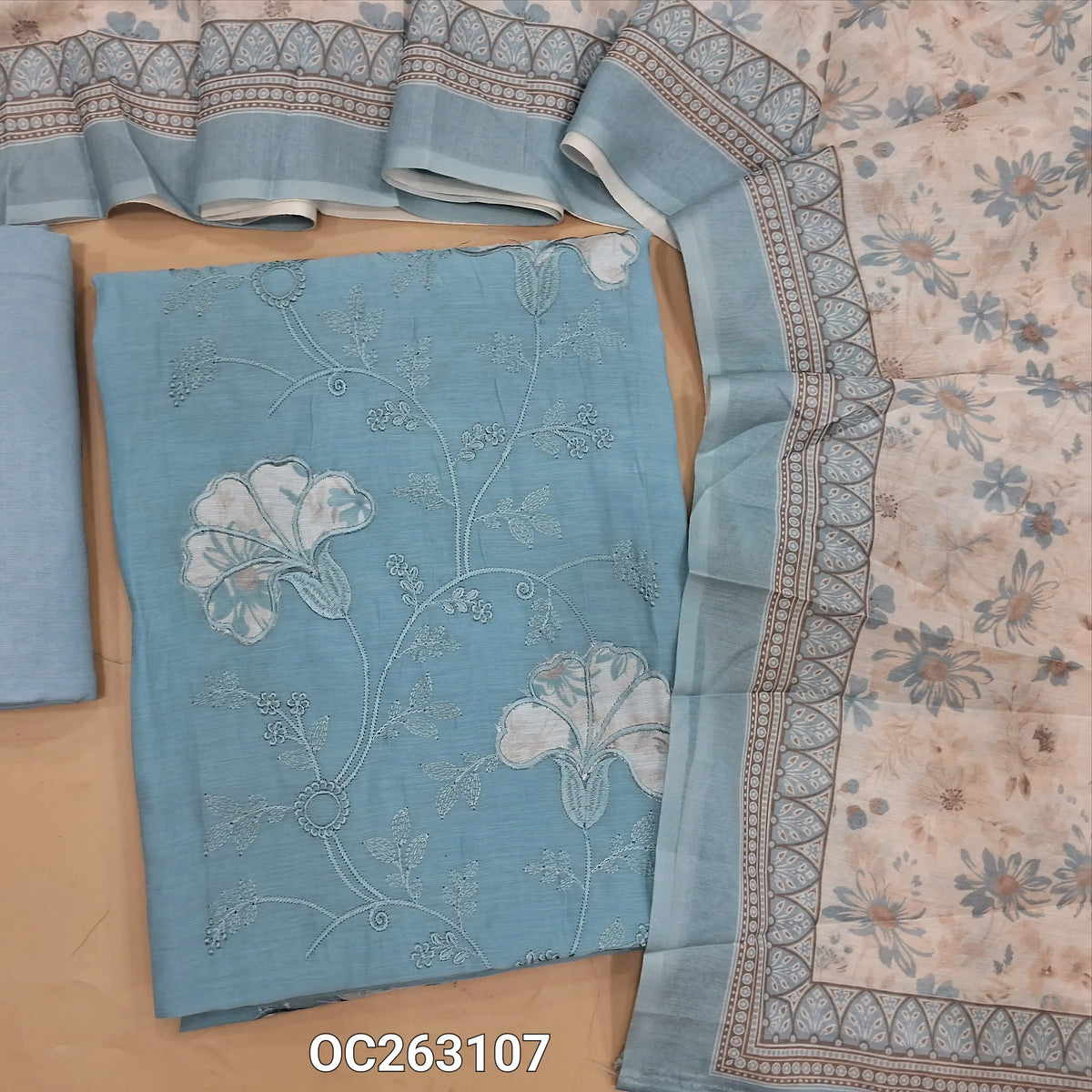 Powder blue mul chanderi unstitched salwar material, applique work on panel, embroidery on front (Thin, Soft, Lining Needed) matching santoon bottom, silk cotton digital printed dupatta. OC263107