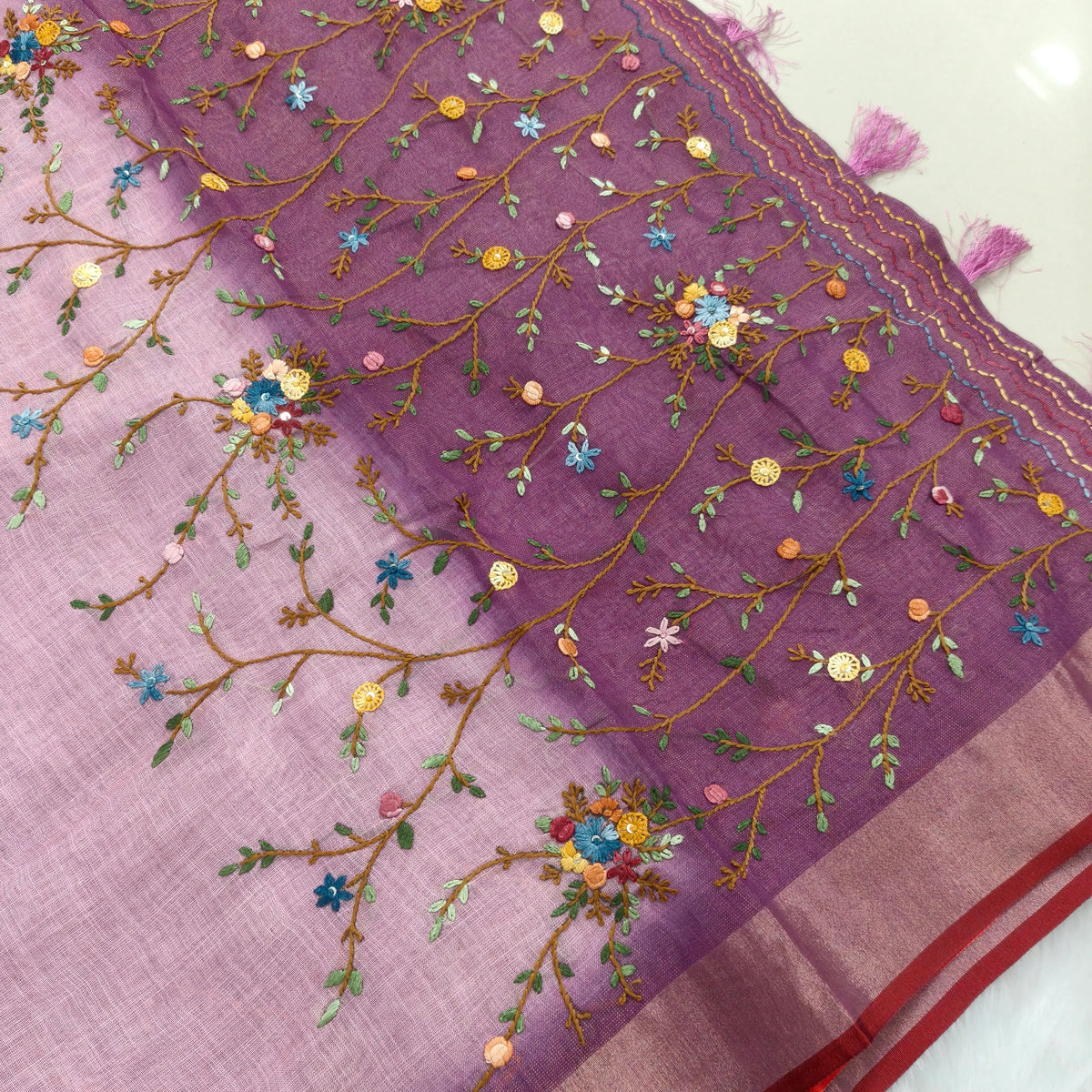 Purple with golden tint premium dual shaded tissue linen saree, with rich hand embroidery work all over(texture)double side tissue borders,contrast pallu, with rich hand embroidery and sequins work, running blouse with embroidery & borders. NS265