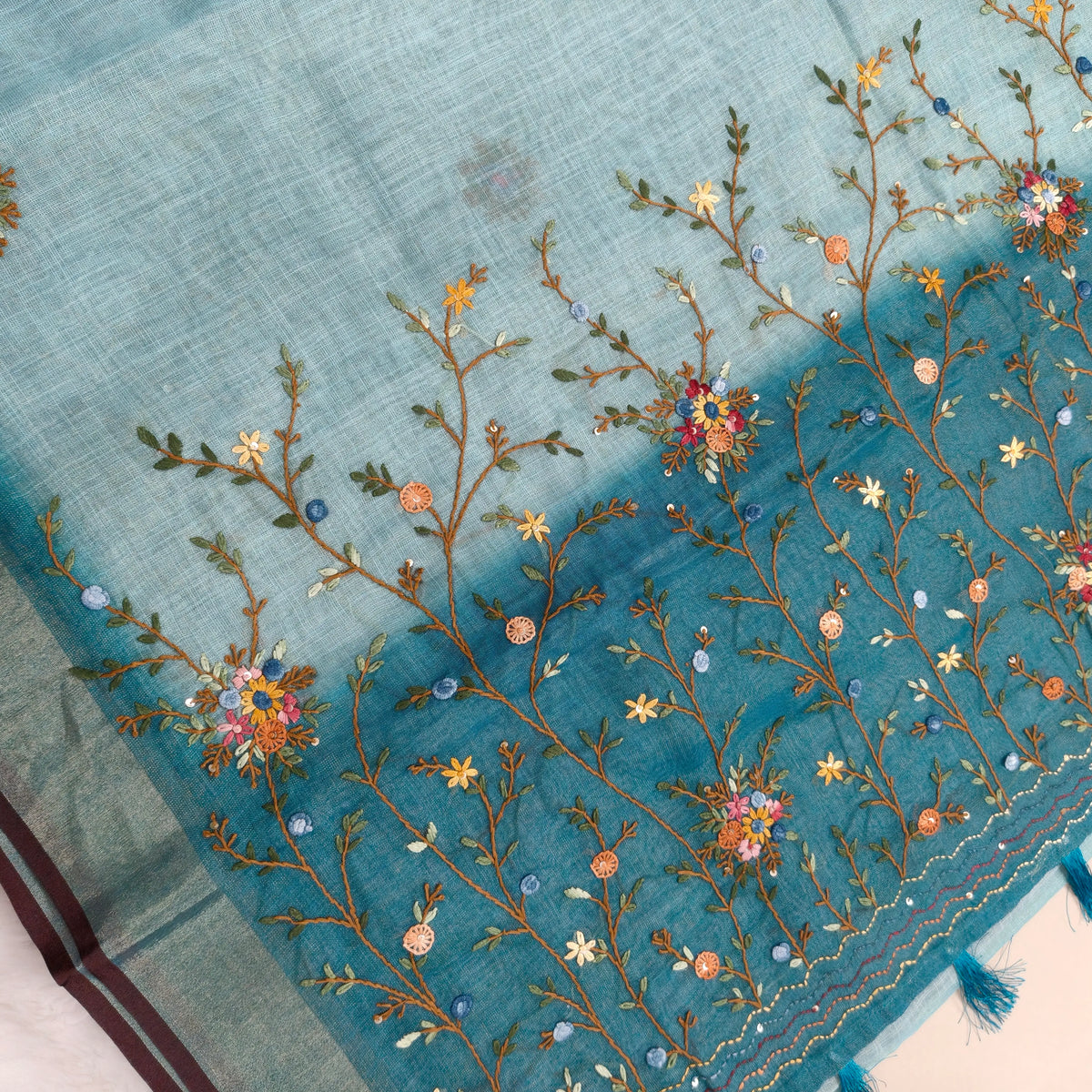 Teal blue with golden tint premium dual shaded tissue linen saree, with rich hand embroidery work all over(texture)double side tissue borders,contrast pallu, with rich hand embroidery and sequins work, running blouse with embroidery & borders. NS264