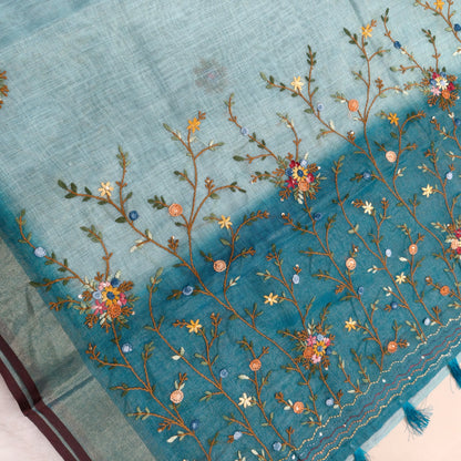Teal blue with golden tint premium dual shaded tissue linen saree, with rich hand embroidery work all over(texture)double side tissue borders,contrast pallu, with rich hand embroidery and sequins work, running blouse with embroidery & borders. NS264
